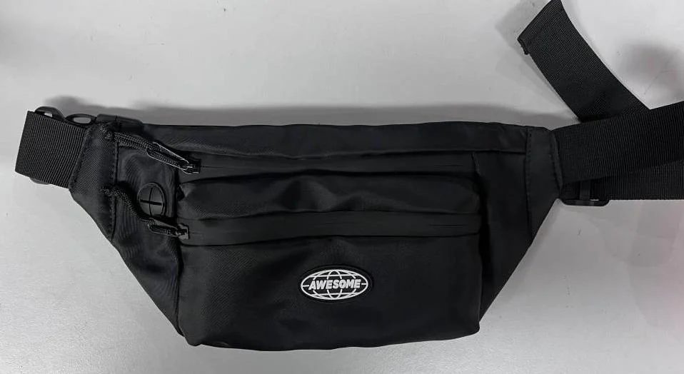 Black waist bag with separate zipper openings, webbing and a front patch